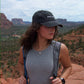 Woman standing on a scenic overlook with mountains in the background